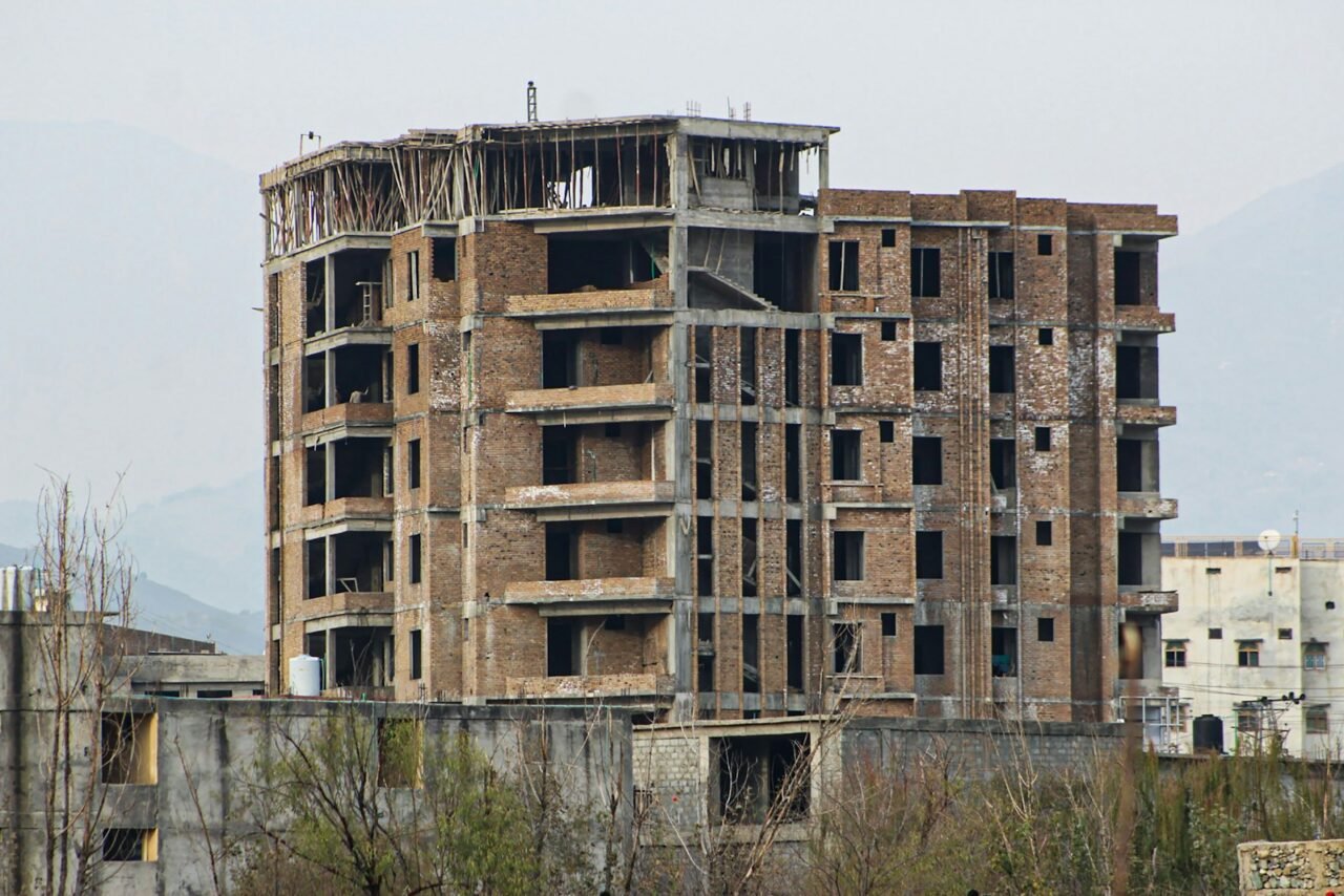 Unfinished residential building showing concrete and brick construction work