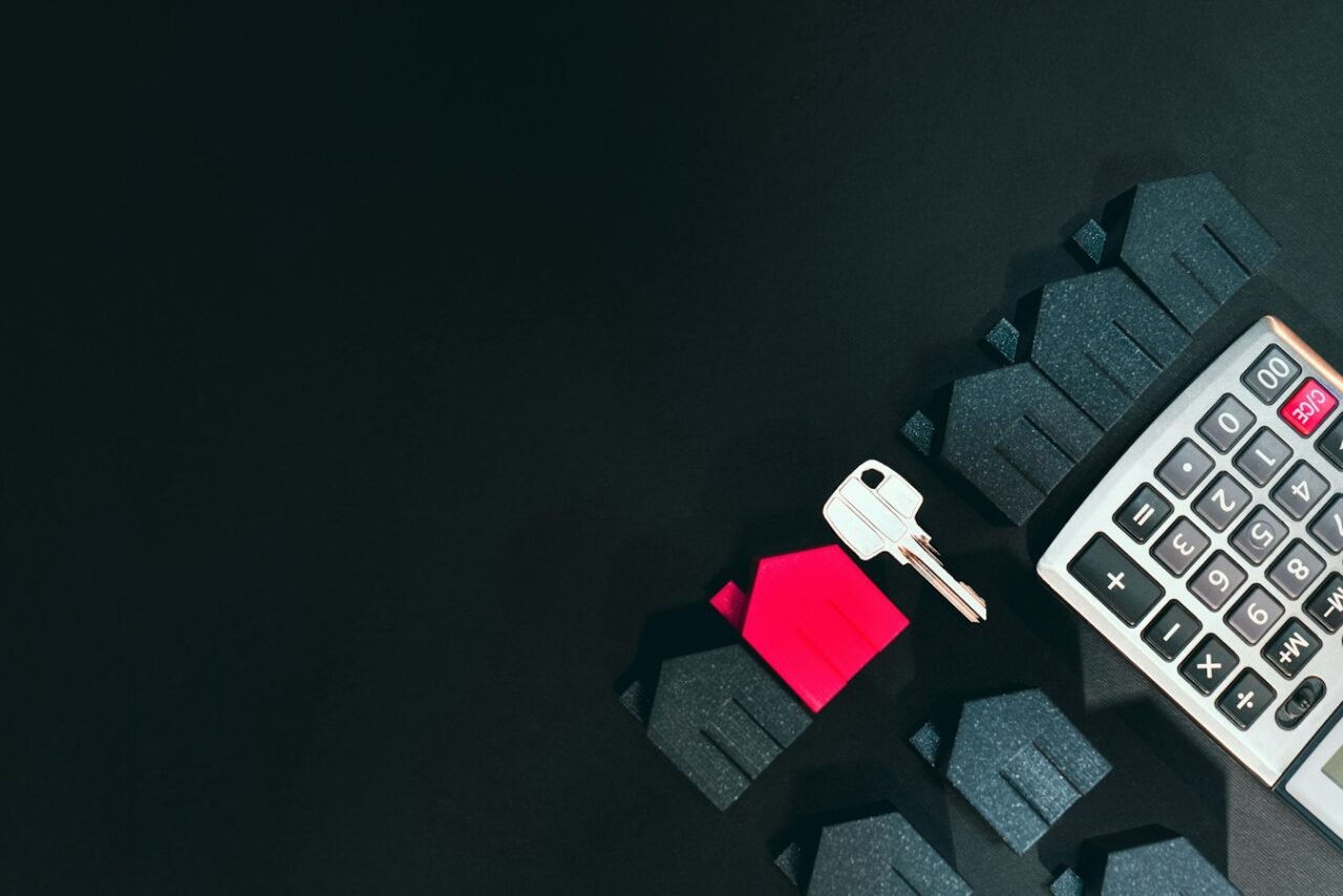 House key and calculator representing property financing and mortgage planning in Pakistan
